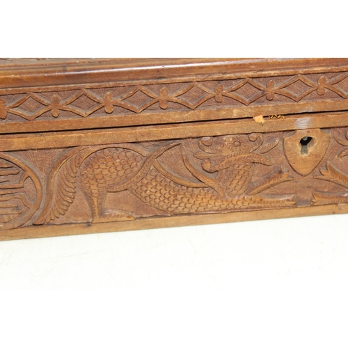293 - An Oriental carved wooden box decorated with dragon and other mythical beasts, likely early 20th cen... 