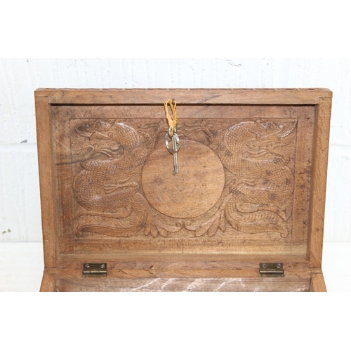 293 - An Oriental carved wooden box decorated with dragon and other mythical beasts, likely early 20th cen... 