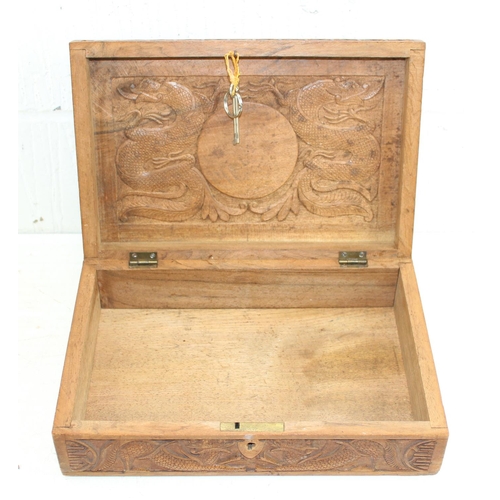 293 - An Oriental carved wooden box decorated with dragon and other mythical beasts, likely early 20th cen... 