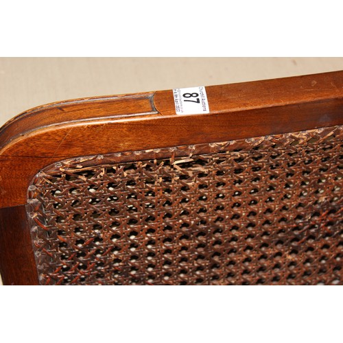 87 - An Art Deco period bergere seated sofa and armchair with mahogany frame