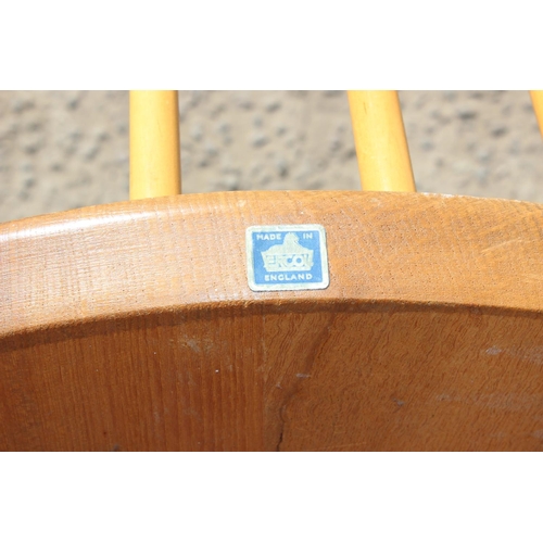 175 - A single blonde Ercol hoop back dining chair with blue & gold label