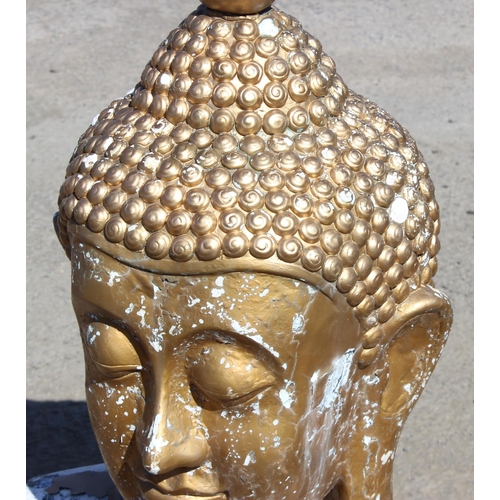 310 - A large gilt painted figure of a Buddhistic deity head