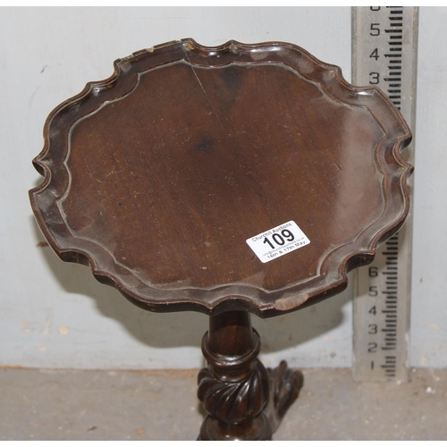 109 - A small antique mahogany wine table with impressive carving