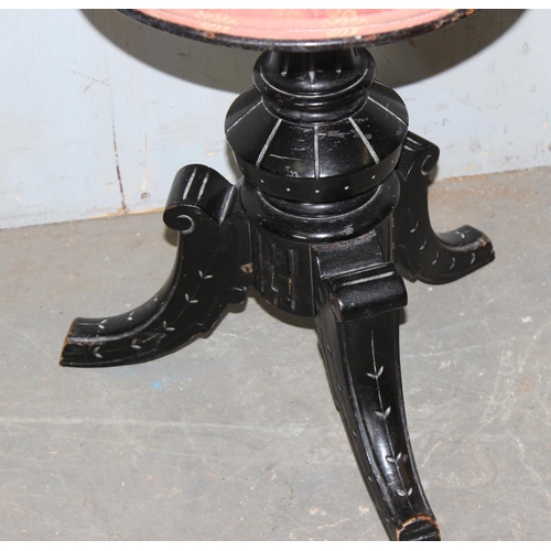 110 - A Victorian ebonised piano stool with screw top