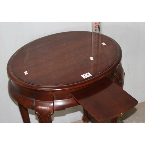 115 - A 20th century oval table with side stand