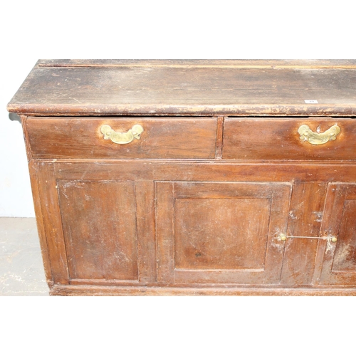 20 - A 19th century scumbled pine dresser base with 2 cupboards and 3 drawers, interesting advertising re... 