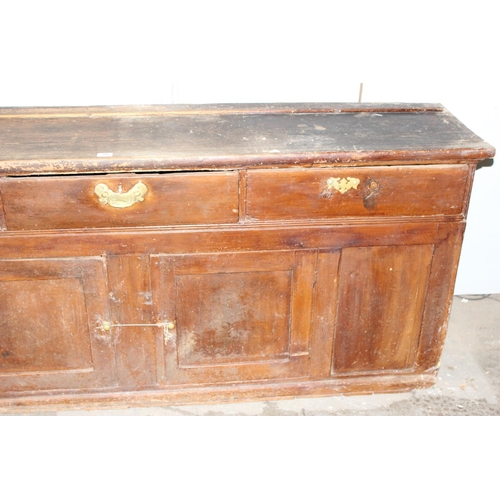 20 - A 19th century scumbled pine dresser base with 2 cupboards and 3 drawers, interesting advertising re... 