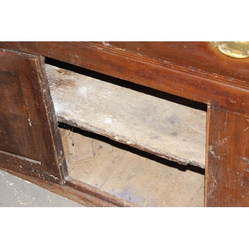 20 - A 19th century scumbled pine dresser base with 2 cupboards and 3 drawers, interesting advertising re... 