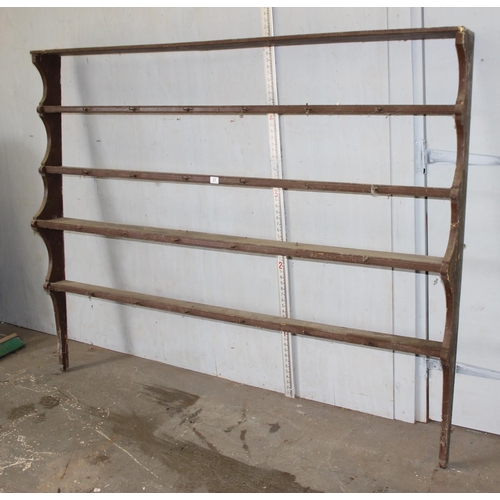 21 - An antique scumbled pine 4 shelf wall mounted plate rack, approx 77