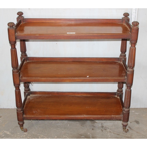 23 - A Victorian mahogany 3 tier buffet, with carved dome shaped finials and raised on turned supports wi... 