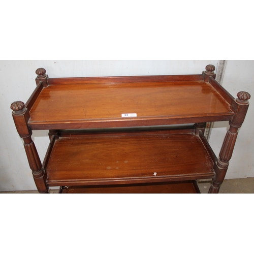 23 - A Victorian mahogany 3 tier buffet, with carved dome shaped finials and raised on turned supports wi... 