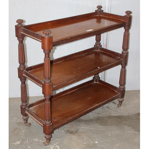 23 - A Victorian mahogany 3 tier buffet, with carved dome shaped finials and raised on turned supports wi... 