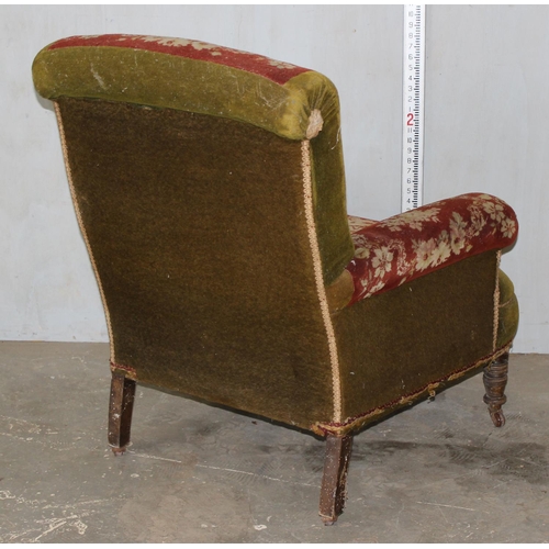 27 - An antique carpet upholstered deep seated armchair on turned wooden legs and metal and ceramic casto... 