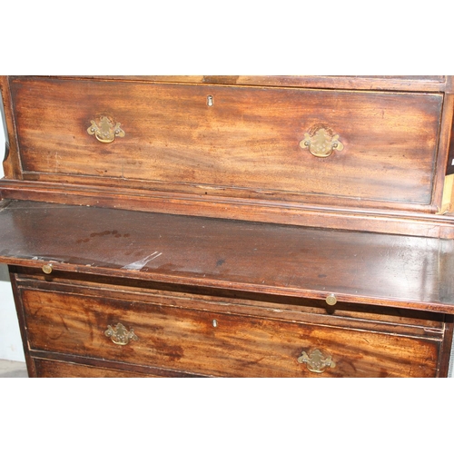 28 - A large Georgian mahogany tall boy or chest on chest, standing on bracket feet with brass fittings