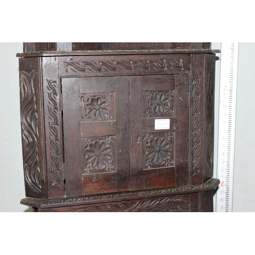 29 - An unusual 17th century style Oak corner cabinet with carved details