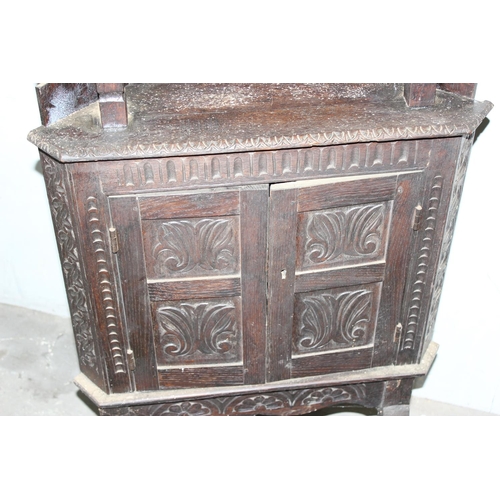 29 - An unusual 17th century style Oak corner cabinet with carved details