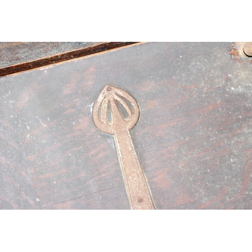 32 - An early 20th century oak bureau with interesting Art Nouveau strapwork handles