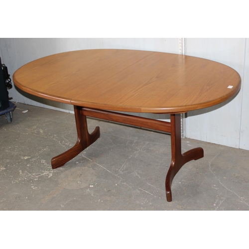 5 - A retro oval shaped G-Plan teak dining table with fold out leaf, approx 64