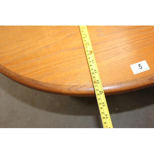 5 - A retro oval shaped G-Plan teak dining table with fold out leaf, approx 64