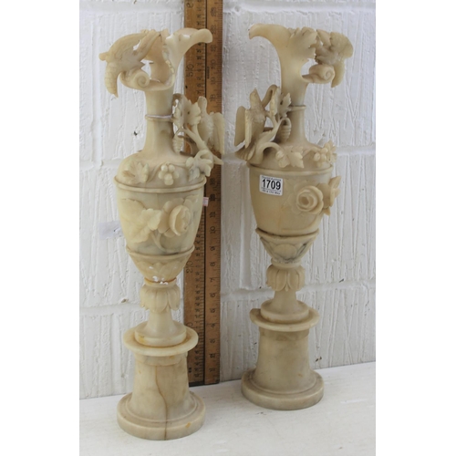 1709 - A large pair of classical style carved alabaster ewers decorated with birds and flora, likely 19th c... 