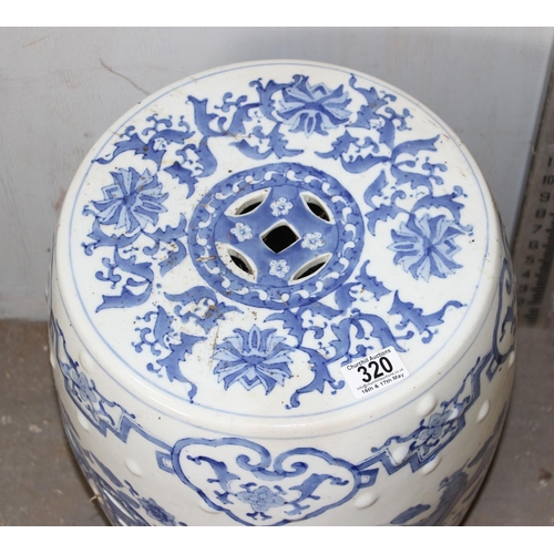 320 - A large 20th century Chinese blue & white pottery garden seat decorated with dragons