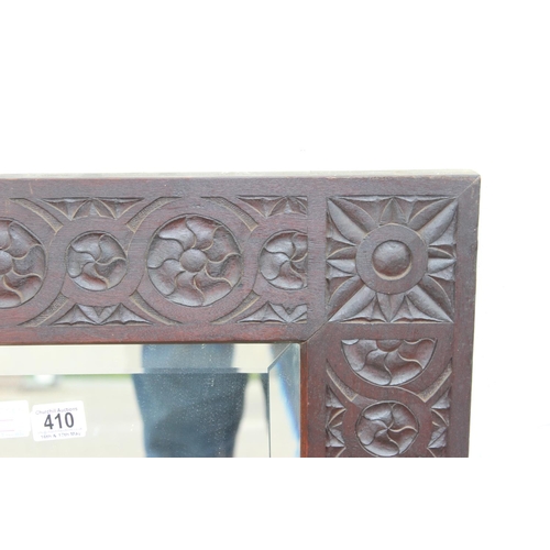 410 - An Arts & Crafts period carved oak mirror