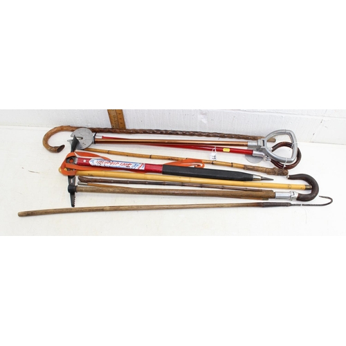 751 - Qty of assorted walking sticks, shooting sticks, ice axe, gaff etc