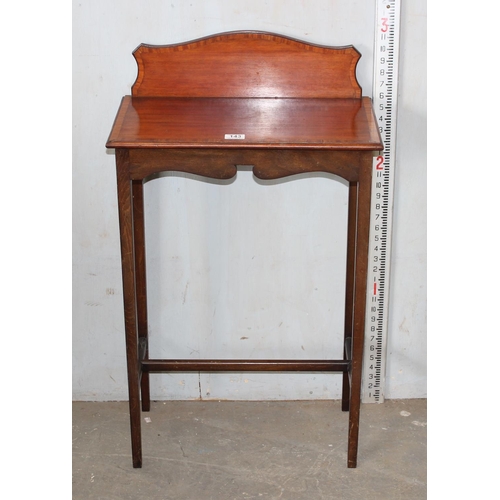 143 - An Edwardian mahogany side table with shaped back