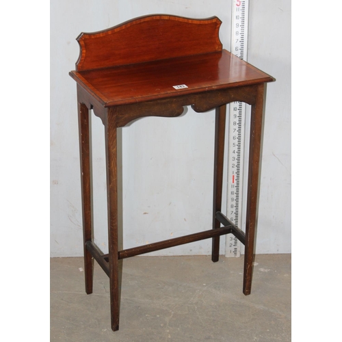 143 - An Edwardian mahogany side table with shaped back