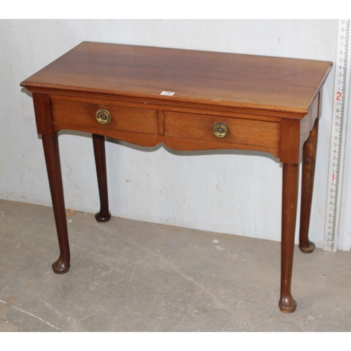 148 - A 20th century antique style hall table with 2 drawers standing on pad feet