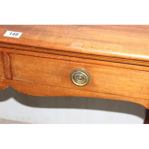 148 - A 20th century antique style hall table with 2 drawers standing on pad feet