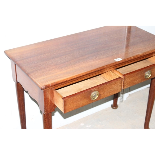 148 - A 20th century antique style hall table with 2 drawers standing on pad feet