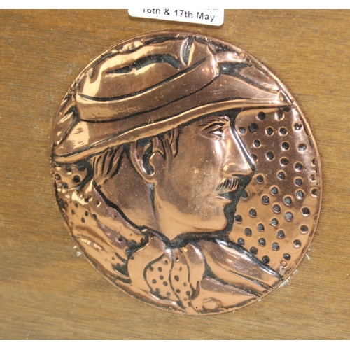 282 - An early 20th century copper mounted tray depicting a male face, possibly Howard Carter