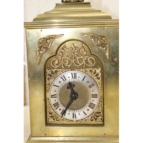 1426 - A vintage brass cased mantel or bracket clock having a silvered dial with Roman numerals with pierce... 