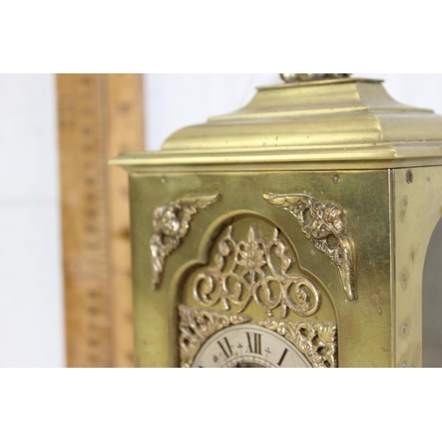 1426 - A vintage brass cased mantel or bracket clock having a silvered dial with Roman numerals with pierce... 