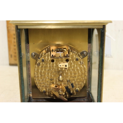 1426 - A vintage brass cased mantel or bracket clock having a silvered dial with Roman numerals with pierce... 