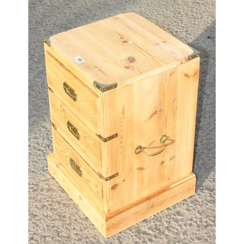 184 - A pair of modern pine bedside cabinets with campaign style brass handles and corners