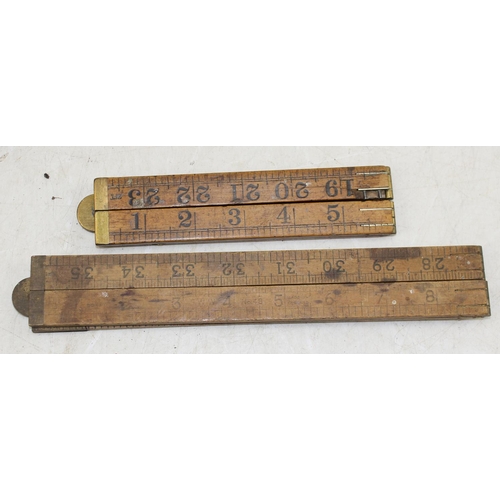 725 - A qty of antique folding wooden rulers, vintage tape measures etc