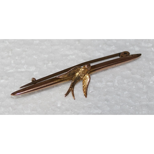 1233 - 9ct gold bar brooch formed with a swallow, approx 1.6g gross