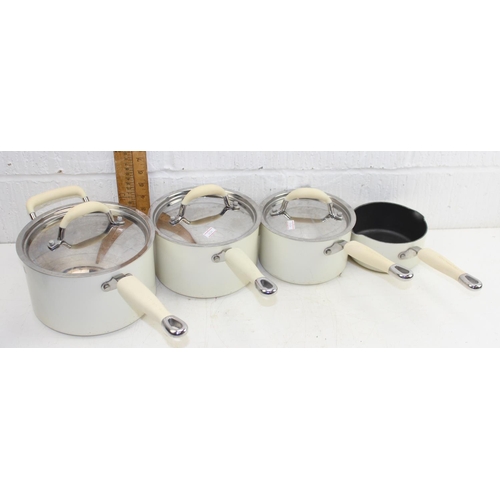 1848 - A set of 4 cream Kitchen Aid saucepans, 3 with lids