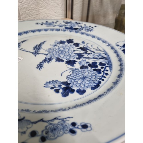 1684 - A large 18th/ 19th century Chinese porcelain charger with blue and white decoration of flowers, appr... 