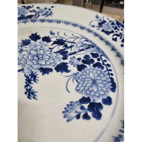 1684 - A large 18th/ 19th century Chinese porcelain charger with blue and white decoration of flowers, appr... 