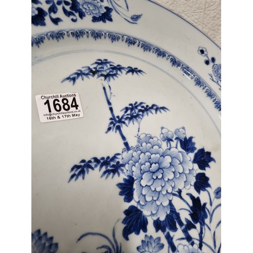 1684 - A large 18th/ 19th century Chinese porcelain charger with blue and white decoration of flowers, appr... 