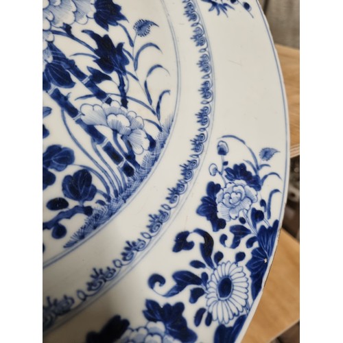 1684 - A large 18th/ 19th century Chinese porcelain charger with blue and white decoration of flowers, appr... 