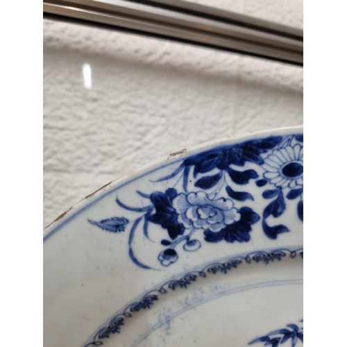 1684 - A large 18th/ 19th century Chinese porcelain charger with blue and white decoration of flowers, appr... 