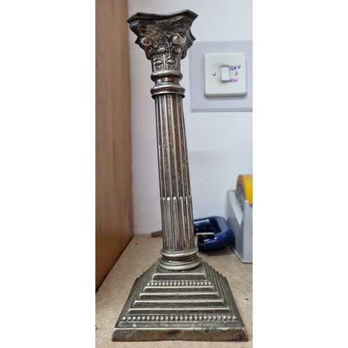 1168 - A pair of silver plated candlesticks formed as Corinthian columns