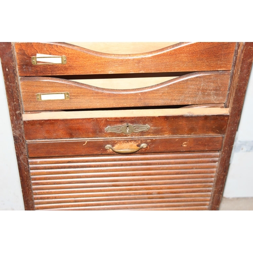 1 - An early 20th century oak tambour fronted cabinet, with key