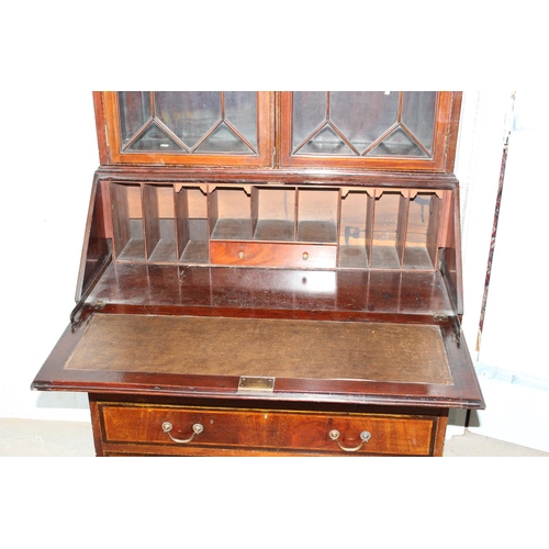 18 - An antique bureau bookcase with glazed top and brass drop handles