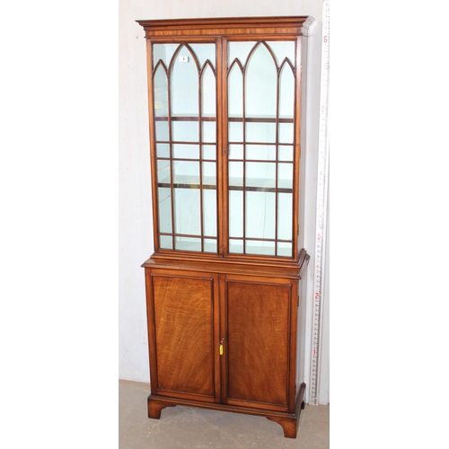 4 - An antique glazed mahogany bookcase with cupboard base