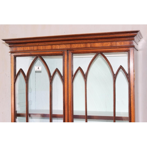 4 - An antique glazed mahogany bookcase with cupboard base